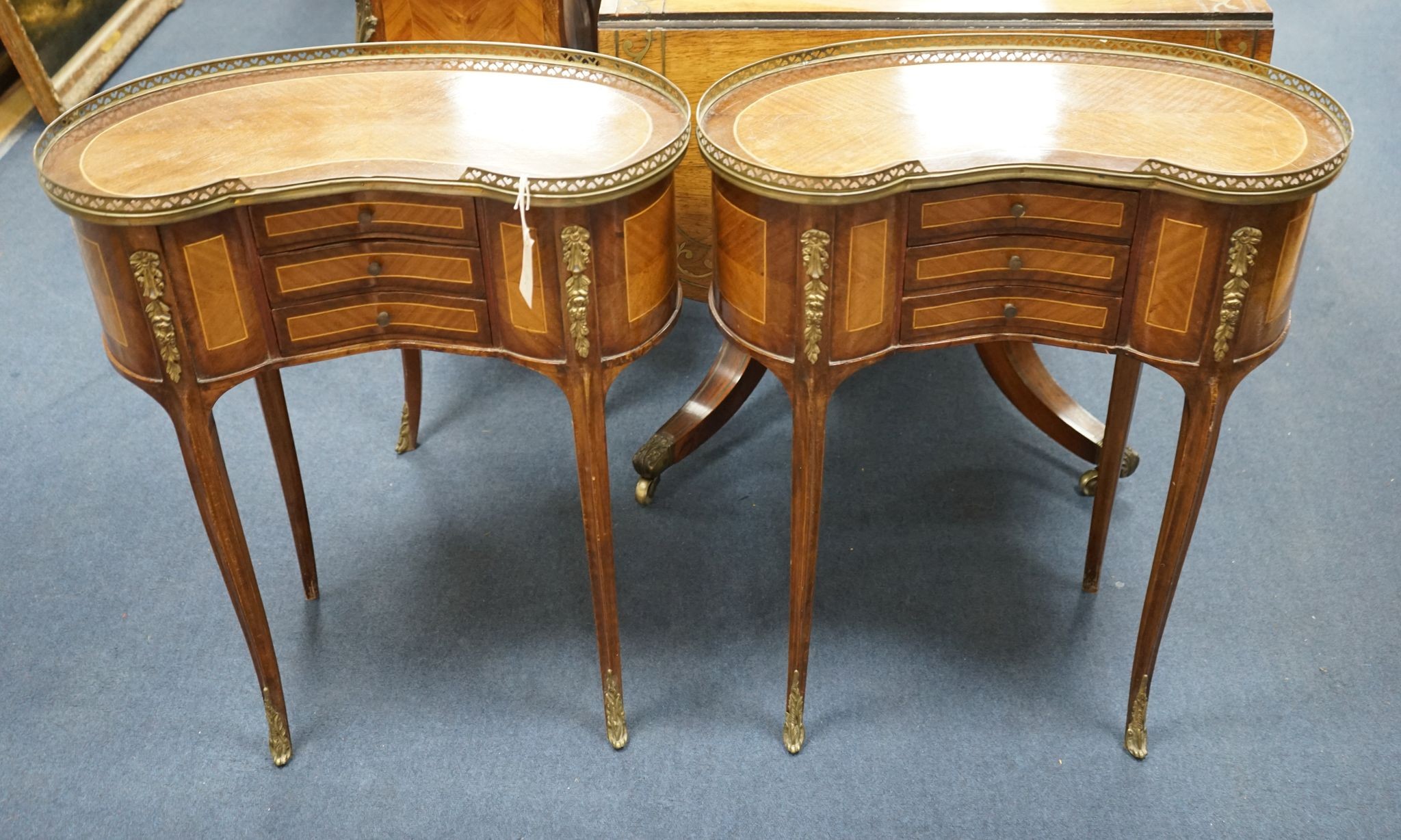 A pair of Louis XV design galleried kidney shaped occasional tables, width 59cm, depth 29cm, height 71cm